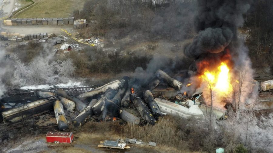 Black smoke billows over the wreckage at the site of a train derailment.