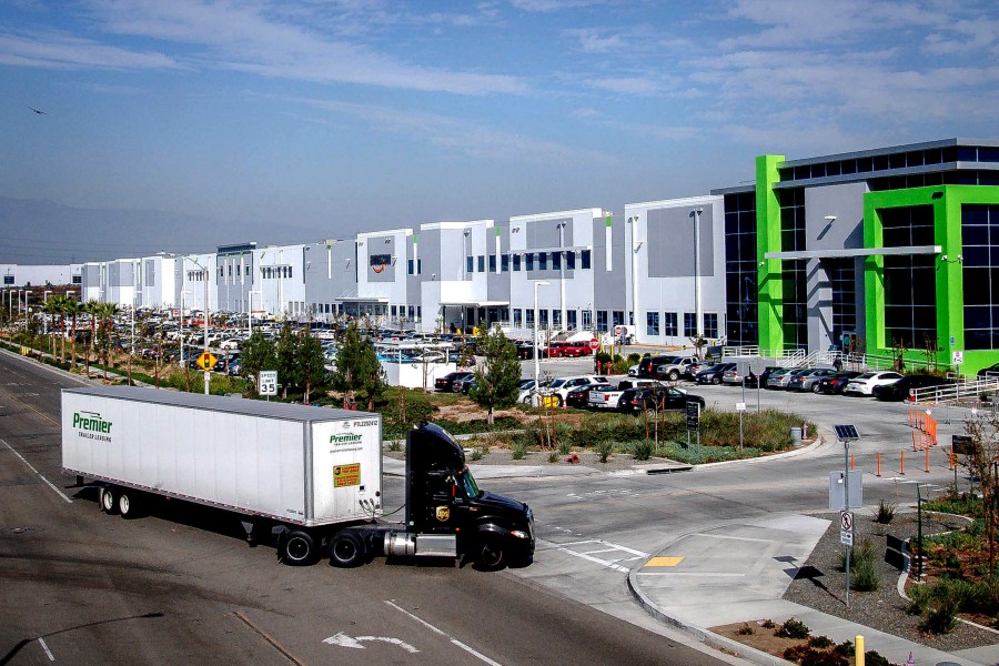 FILE - A semi-truck turns into an Amazon Fulfillment center in Eastvale, Calif. on Thursday, Nov. 12, 2020. An internal Amazon memo has provided a stark look at the company’s carefully laid out plans to grow its influence in Southern California through a plethora of efforts that include burnishing its reputation through charity work and pushing back against “labor agitation” from the Teamsters and other groups. (Watchara Phomicinda/The Orange County Register via AP, File)