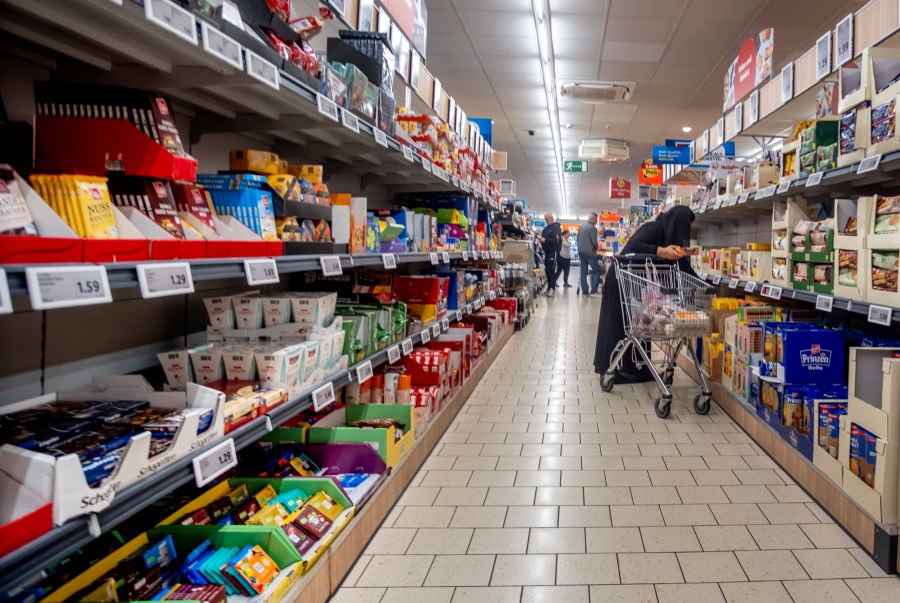 FILE - A woman shops in a discount market in Frankfurt, Germany, Friday, July 28, 2023. Germany's economy is likely to shrink again slightly in the current fourth quarter, the country's central bank said Monday, while a survey showed business confidence in Europe's biggest economy retreating unexpectedly. (AP Photo/Michael Probst, File)