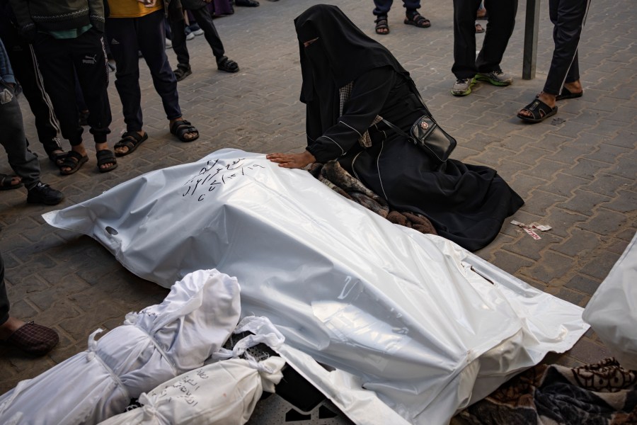 Palestinians mourn their relatives killed in the Israeli bombardment of the Gaza Strip, at the hospital Rafah, southern Gaza, Tuesday, Dec. 19, 2023. (AP Photo/Fatima Shbair)