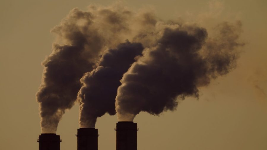 FILE - Emissions rise from the smokestacks at the Jeffrey Energy Center coal power plant as the sun sets, near Emmett, Kan., Sept. 18, 2021.