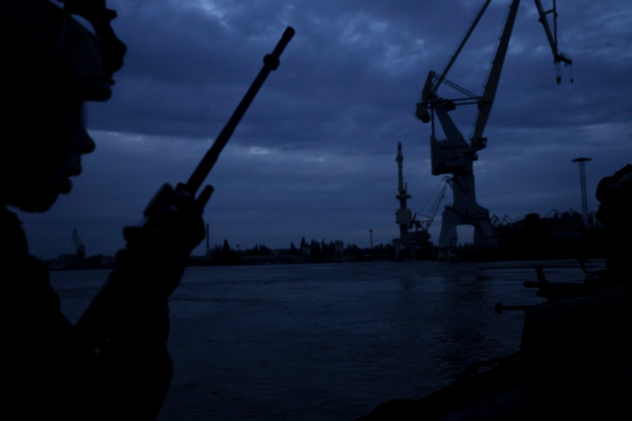 A Ukraine Special Operations Forces officer talks on the radio while navigating the Dnipro River during a night mission in Kherson region, in Kherson, Ukraine, Sunday, June 11, 2023. (AP Photo/Felipe Dana)