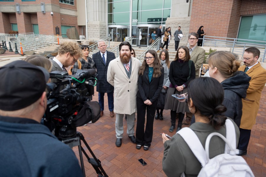 Jennifer Adkins and her husband, John, from Caldwell, Idaho talk to the media outside the Ada County Courthouse Thursday, Dec. 14, 2023 in Boise, Idaho. The two are plaintiffs in a case concerning access to abortive care in Idaho. An attorney for Idaho asked a judge on Thursday to throw out a lawsuit seeking clarity about the medical exemptions to the state's broad abortion bans, saying it was based on hypothetical situations rather than current facts. (AP Photo/Kyle Green)