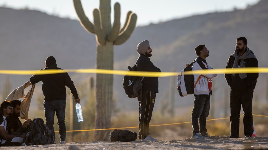 Immigrants arrive to a remote U.S. Border Patrol processing center after crossing the U.S.-Mexico border on December 7, 2023 in Lukeville, Arizona.