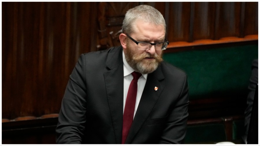 Far-right lawmaker Grzegorz Braun speaks to parliament in Warsaw, Poland, on Dec. 11, 2023. Braun used a fire extinguisher on Tuesday and put out the burning candles on a menorah that were lit for the Jewish holiday Hanukkah in the parliament, sparking condemnation of other politicians. (AP Photo/Czarek Sokolowski)