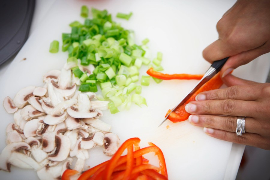 Lockeed Martin senior research scientist Maya Cooper chops vegetables, which would be feasable for astronauts in Mars gravity, for a vegan pizza developed at NASA's Advanced Food Technology Project at Johnson Space Center in Houston Tuesday, July 3, 2012