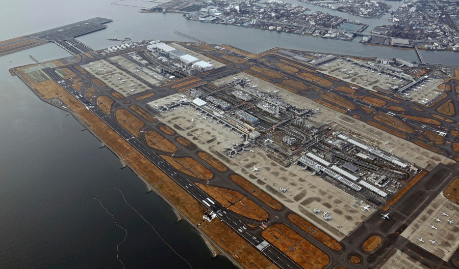 The burn-out wreckages of the Japan Airlines plane, bottom right, and the Japanese coast guard aircraft, left top, are seen at Haneda airport on Wednesday, Jan. 3, 2024, in Tokyo, Japan. The large passenger plane and the Japanese coast guard aircraft collided on the runway at Tokyo's Haneda Airport on Tuesday and burst into flames, killing several people aboard the coast guard plane, officials said. (Kyodo News via AP)