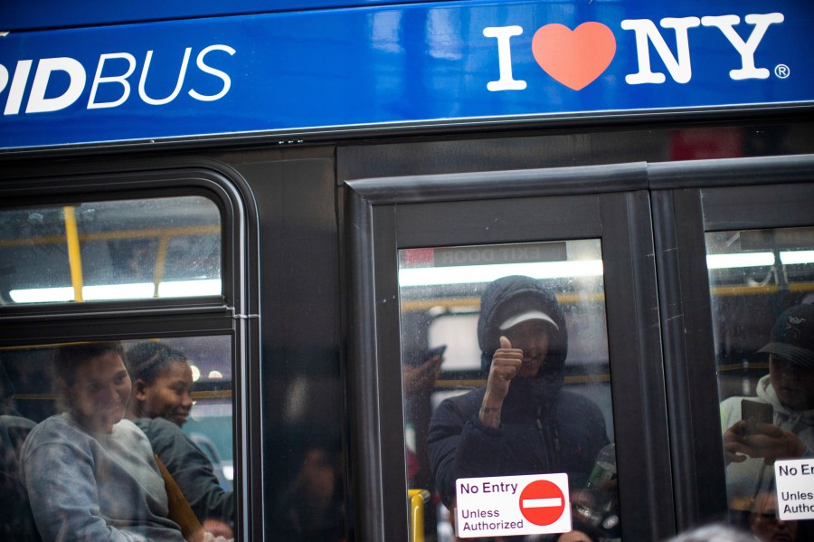 FILE - Asylum seekers arrive at the Roosevelt Hotel on Friday, May 19, 2023, in New York. New York City is suing more than a dozen charter bus companies for their role in Texas Gov. Greg Abbott's operation to send tens of thousands of migrants to urban areas, Thursday, Jan. 4, 2024. (AP Photo/Eduardo Munoz Alvarez)