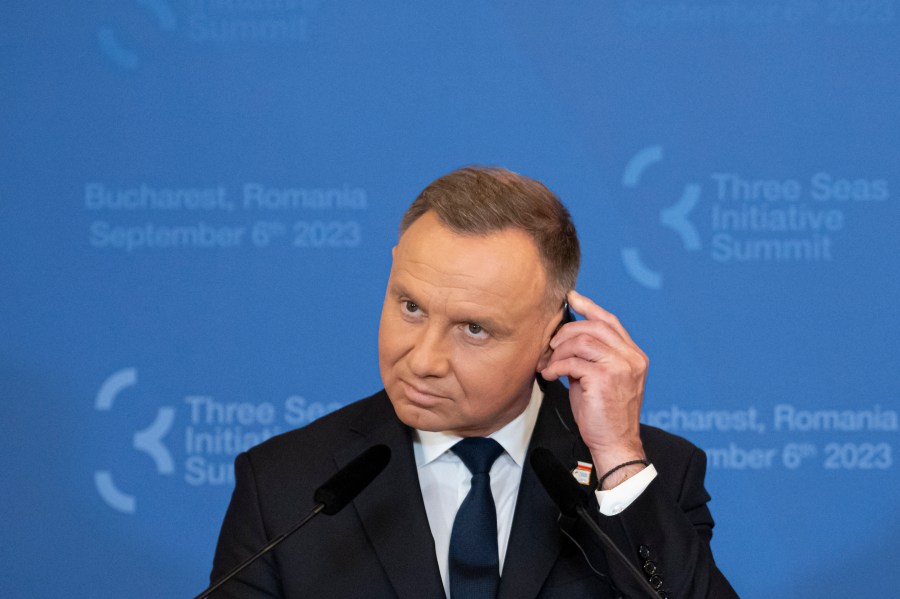 FILE - Poland's President Andrzej Duda adjusts his headphones during a press conference at the Cotroceni Presidential Palace in Bucharest, Romania, Wednesday, Sept. 6, 2023. Poland's minister of digital affairs suggested Friday, Jan. 5, 2024, that President Andrzej Duda check the security of access to his social accounts after a bizarre tweet went out that was almost immediately removed. (AP Photo/Andreea Alexandru, File)