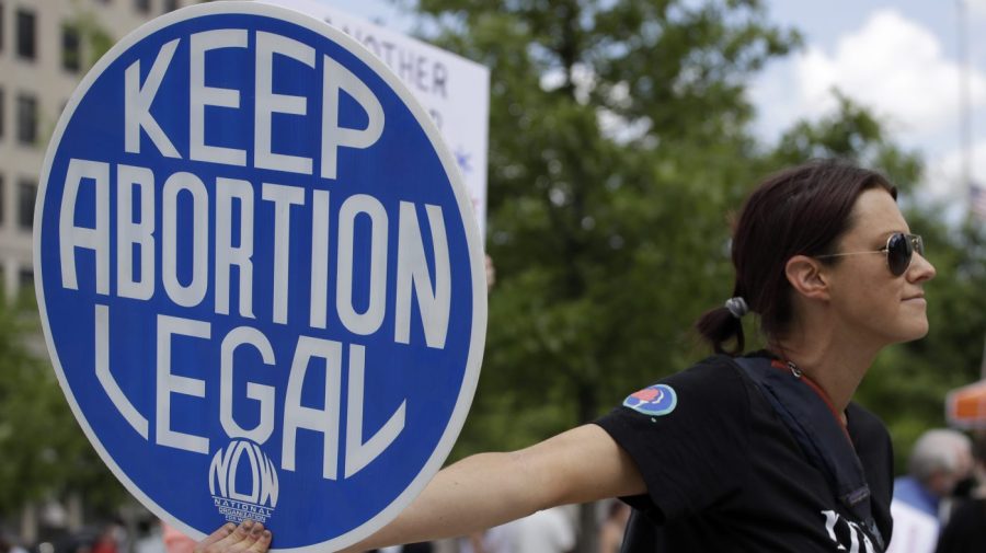 An abortion-rights demonstrator holds a sign that says "Keep Abortion Legal" during a rally, May 14, 2022, in Chattanooga, Tenn.