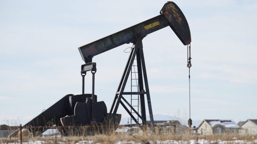 An oil pumper stands in a field along Interstate 25 on Thursday, Nov. 30, 2023, near Erie, Colo. On Friday, the Labor Department releases producer prices data for December.(AP Photo/David Zalubowski)