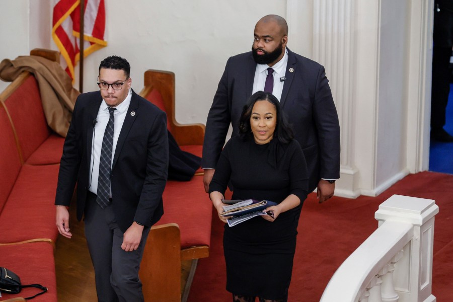 Fulton County District Attorney Fani Willis, right, enters the Big Bethel AME Church in Atlanta, moments before the worship service, where she was invited to speak on Sunday, Jan. 14, 2024. The service celebrated Rev. Martin Luther King Jr. at the historic Black church. (Miguel Martinez/Atlanta Journal-Constitution via AP)