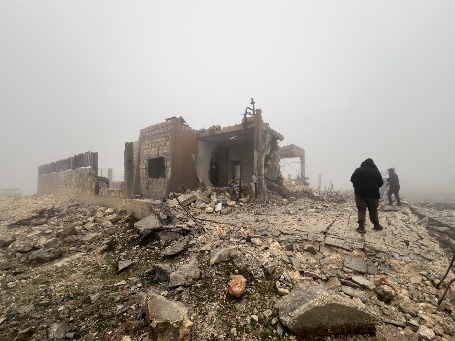 Syrians look at an abandoned medical facility in the village of Talteta, Syria, Tuesday, Jan. 16, 2024, that was hit by Iranian missiles late Monday night, according to a voluntary rescue group White Helmets. Iran fired missiles late Monday at what it claimed was Israeli "spy headquarters" near the U.S. Consulate in the northern Iraqi city of Irbil and at targets linked to the extremist group Islamic State in northern Syria. (AP Photo/Omar Albam)