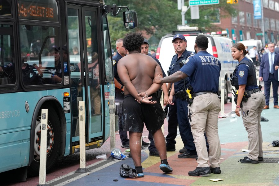 FILE - New York City Police Department officers arrest a man, Aug. 4, 2023, in New York's Union Square. New York Mayor Eric Adams announced Friday, Jan 19, 2024, that he rejected a bill, known as the "How Many Stops Act," which requires officers to publicly report on all investigative stops, including relatively low-level encounters with civilians. The Democratic-led City Council approved the measure in the final days of 2023 with enough votes to overrule a mayoral veto and ensure that the bill becomes law unless several members change their stance. (AP Photo/Mary Altaffer, File)