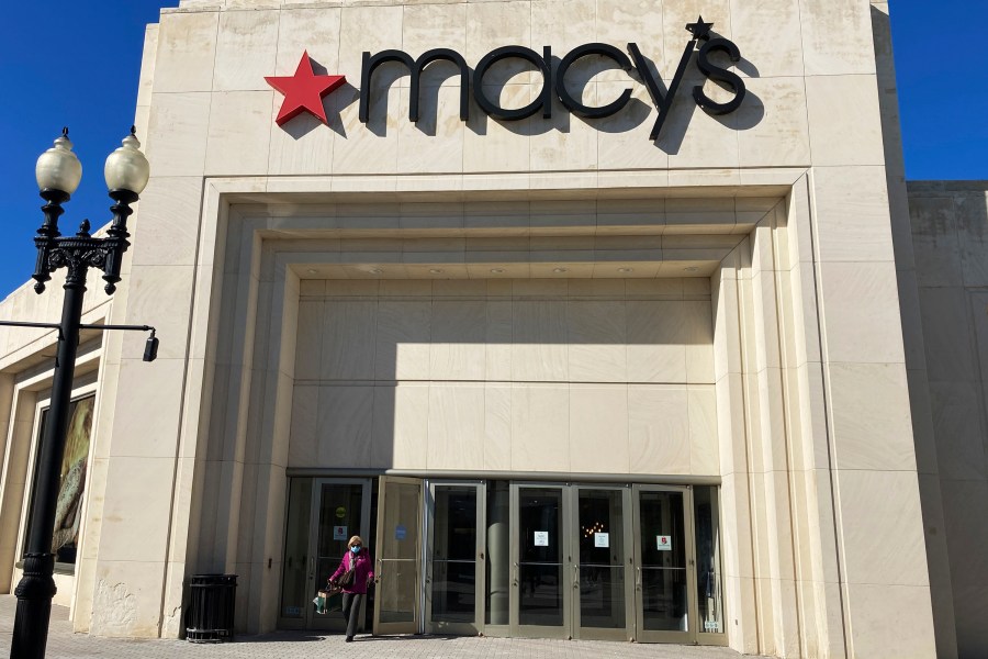 FILE - A shopper exits Macy's at the Woodfield Old Orchard Shopping Center in Skokie, Ill., Feb. 19, 2022. Macy’s is rejecting a $5.8 billion takeover offer from investment firms Arkhouse Management and Brigade Capital Management, saying they didn’t provide a viable financing plan. Arkhouse and Brigade offered $21 per share for the stock they don’t already own. The department store chain also said there was a lack of compelling value in the non-binding proposal. The move comes a week after Macy's announced job cuts and store closures. (AP Photo/Nam Y. Huh, file)