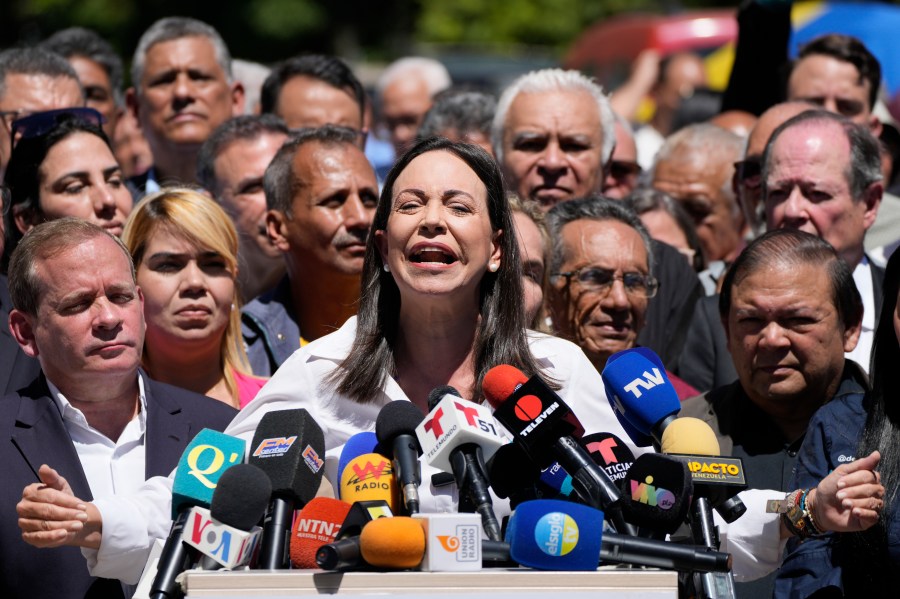 Opposition coalition presidential hopeful Maria Corina Machado gives a press conference outside her campaign headquarters in Caracas, Venezuela, Monday, Jan. 29, 2024, days after the country's highest court upheld a ban on her candidacy. (AP Photo/Ariana Cubillos)