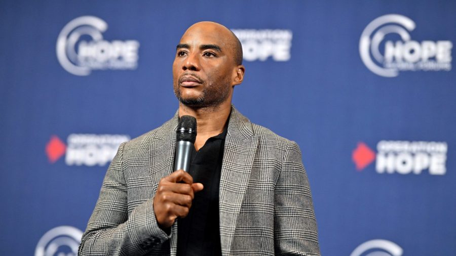 Charlamagne tha God holds a mic during an event.