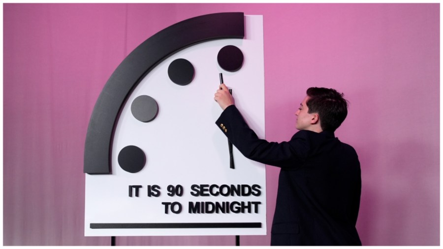 A staffer shows the location of the minute hand shortly before the Bulletin of the Atomic Scientists announces the latest decision on the "Doomsday Clock" minute hand, Tuesday, Jan. 23, 2024, at the National Press Club Broadcast Center, in Washington. This year, Jan. 2024, the clock will remain set to 90 seconds to midnight. (AP Photo/Jacquelyn Martin)