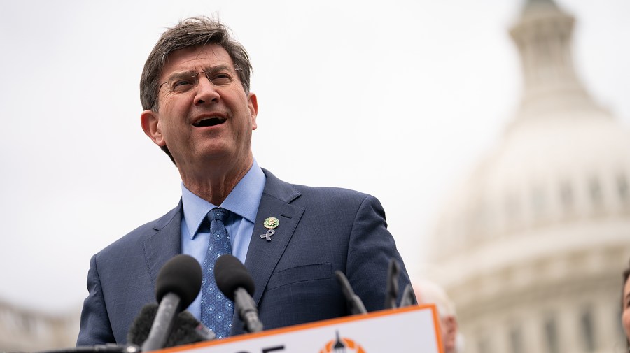 Representative Brad Schneider speaks in front of the Capitol.