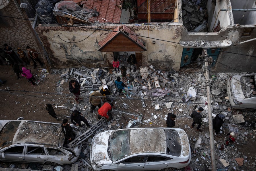 Palestinians look at the destruction after an Israeli airstrike in Rafah, Gaza Strip, Friday, Feb. 9, 2024. (AP Photo/Fatima Shbair)