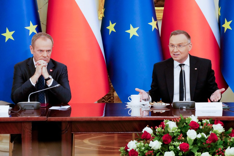 Poland's Prime Minister Donald Tusk, left, and President Andrzej Duda attend a meeting of the Cabinet Council, a consultation format between the president and the government, in Warsaw, Poland, on Tuesday Feb. 13, 2024. Tusk said Tuesday he has documentation proving that state authorities under the previous government used powerful Pegasus spyware illegally and that list of victims" was "very long ". (AP Photo/Czarek Sokolowski)