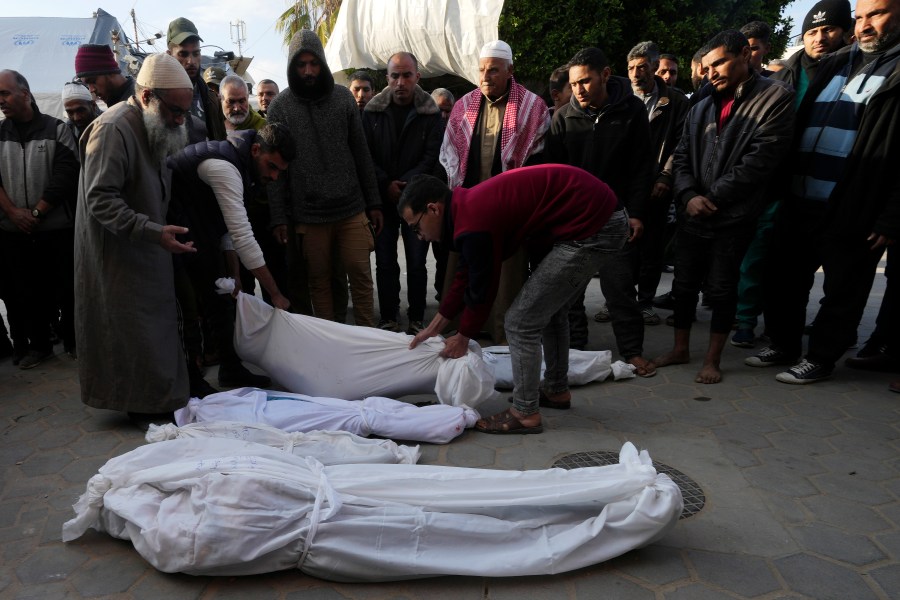 Palestinians carry the bodies of a woman and her four children killed in the Israeli bombardments of the Gaza Strip at Al Aqsa Hospital in Deir al Balah on Tuesday, Feb. 20, 2024. (AP Photo/Adel Hana)