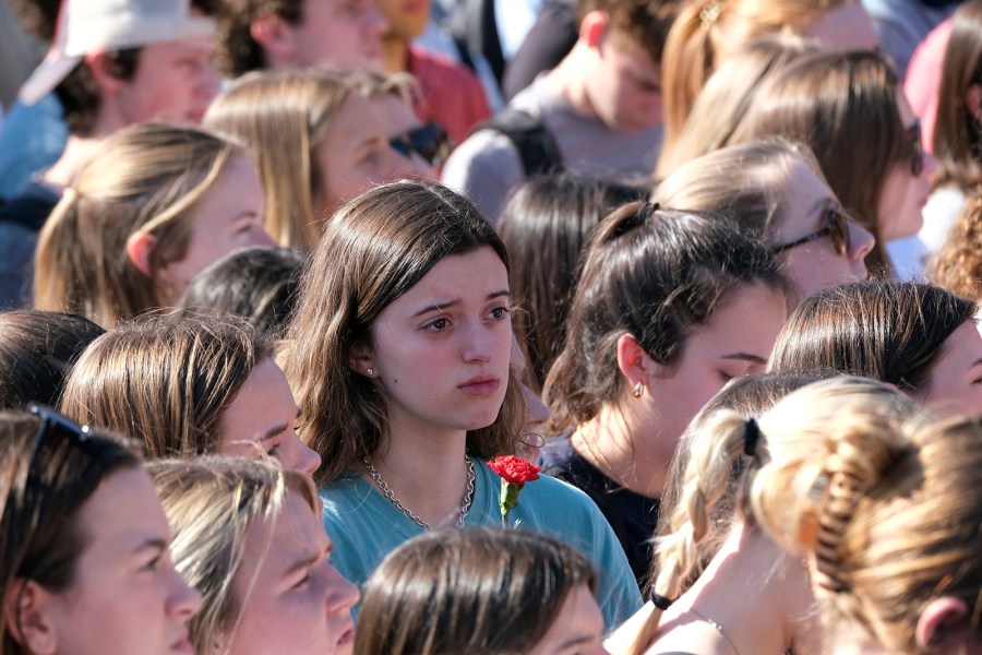 University of Georgia students gather at the Tate Plaza on campus in Athens, Ga., Monday, Feb. 26, 2024, to pay tribute to Laken Riley, a nursing student at Augusta University's Athens campus who was found dead Thursday, Feb. 22, after a roommate reported she didn't return from a morning run in a wooded area of the UGA campus near its intramural fields. UGA students also gathered to pay tribute to a student who committed suicide last week. (Nell Carroll/Atlanta Journal-Constitution via AP)