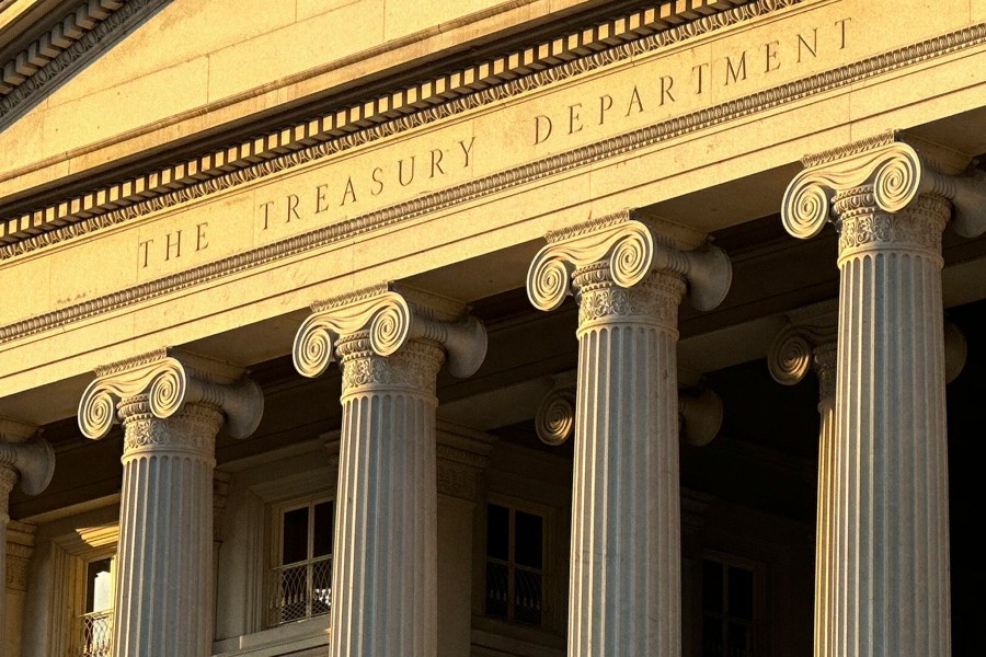 FILE - The Treasury Department is seen near sunset in Washington, Jan. 18, 2023. The U.S. sanctioned a deputy commander of Iran’s Islamic Revolutionary Guard Corps., a Houthi militant member, firms registered in Hong Kong and the Marshall Islands and two ships, including one that transported $100 million in Iranian commodities to China. The sanctions block access to U.S. property and bank accounts and prevent the targeted people and companies from doing business with Americans. (AP Photo/Jon Elswick, File)