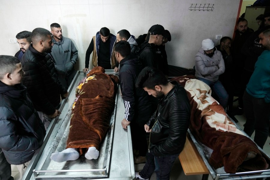 Palestinian mourners bid farewell to men killed by Israeli fire in Faraa refugee camp, at the morgue in the West Bank town of Tubas, Tuesday, Feb. 27, 2024. Israeli troops shot and killed three Palestinian men including Mohammed Daraghmeh, a co-founder of the local branch of Islamic Jihad in the northern town of Tubas, early Tuesday, Palestinian health authorities said. Thee was no immediate comment from the Israeli military. (AP Photo/Majdi Mohammed)