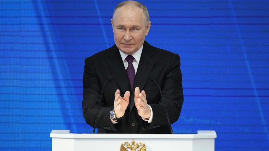 Russian President Vladimir Putin delivers an address on stage.