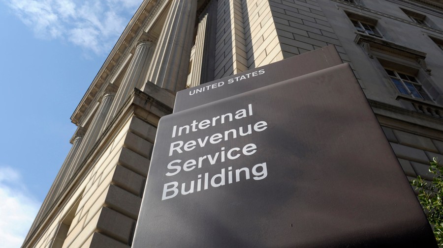 An IRS sign is seen in front of a building.