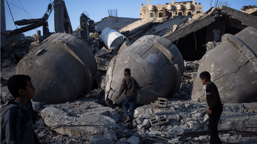 Palestinians look at the destruction after an Israeli strike on residential buildings and a mosque in Rafah, Gaza Strip, Thursday, Feb. 22, 2024.