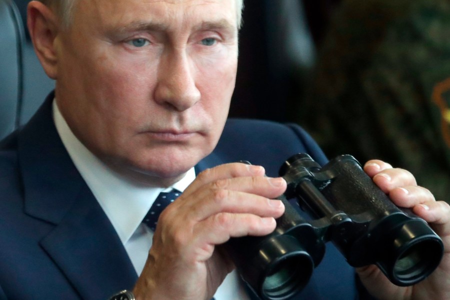 Russian President Vladimir Putin holds a binoculars as he watches the joint strategic exercise of the armed forces of the Russian Federation and the Republic of Belarus Zapad-2021 at the Mulino training ground in the Nizhny Novgorod region, Russia, Sept. 13, 2021.