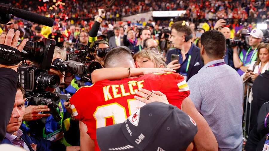 Kansas City Chiefs tight end Travis Kelce celebrates with girlfriend Taylor Swift