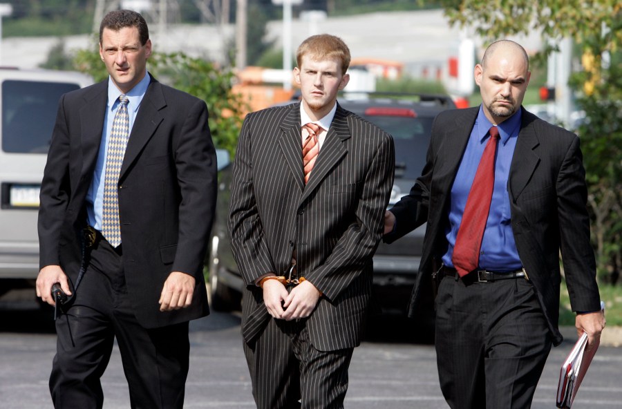 FILE - In this Aug. 29, 2007, file photo, former Kansas City Chiefs assistant coach Britt Reid is escorted into the Montgomery County district court house in Conshohocken, Pa. Missouri Gov. Mike Parson on Friday, March 1, 2024, shortened the prison sentence of Reid for a drunken driving crash that seriously injured a 5-year-old girl. (AP Photo/Matt Rourke, File)