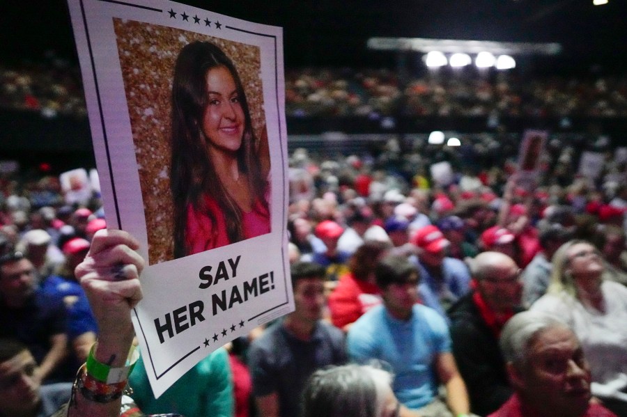 A supporter holds a oster with a photo of Laken Riley before Republican presidential candidate former President Donald Trump speaks at a campaign rally Saturday, March 9, 2024, in Rome Ga. (AP Photo/Mike Stewart)