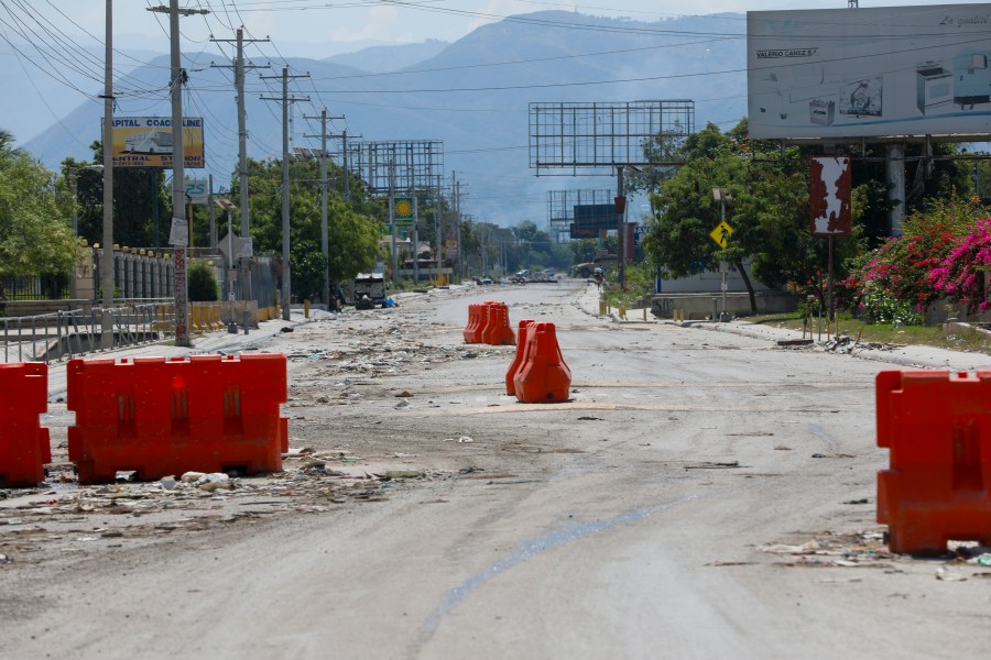 A street alongside the U.S. embassy compound is devoid of traffic in Port-au-Prince, Haiti, Sunday, March 10, 2024. The U.S. military said Sunday that it had flown in forces to bolster security at the delegation and facilitate the departure of nonessential personnel. (AP Photo/Odelyn Joseph)