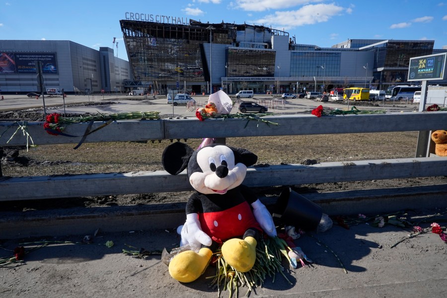 Toys and flowers lie in front of the Crocus City Hall on the western outskirts of Moscow, Russia, Wednesday, March 27, 2024. Russian officials persisted Tuesday in saying Ukraine and the West had a role in last week's deadly Moscow concert hall attack despite vehement denials of involvement by Kyiv and a claim of responsibility by an affiliate of the Islamic State group. (AP Photo/Alexander Zemlianichenko)