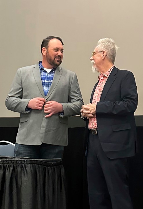 Judd Blevins, left, a city councilor in Enid, Okla., speaks to Enid resident Frank Baker, Tuesday, March 26, 2024, before a community forum. Blevins, who has acknowledged ties to white supremacist groups, faces a recall vote, Tuesday, April 2, 2024. (AP Photo/Sean Murphy)