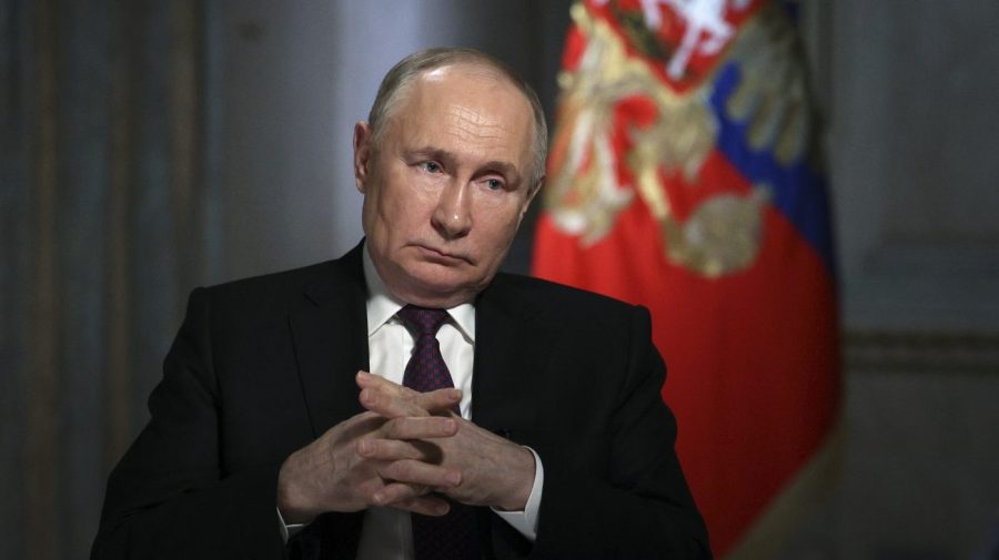 Russian President Vladimir Putin gestures while speaking.