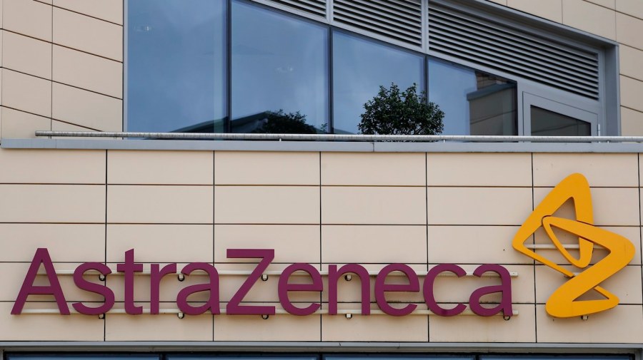 The red and yellow AstraZeneca logo is seen on the side of a building.