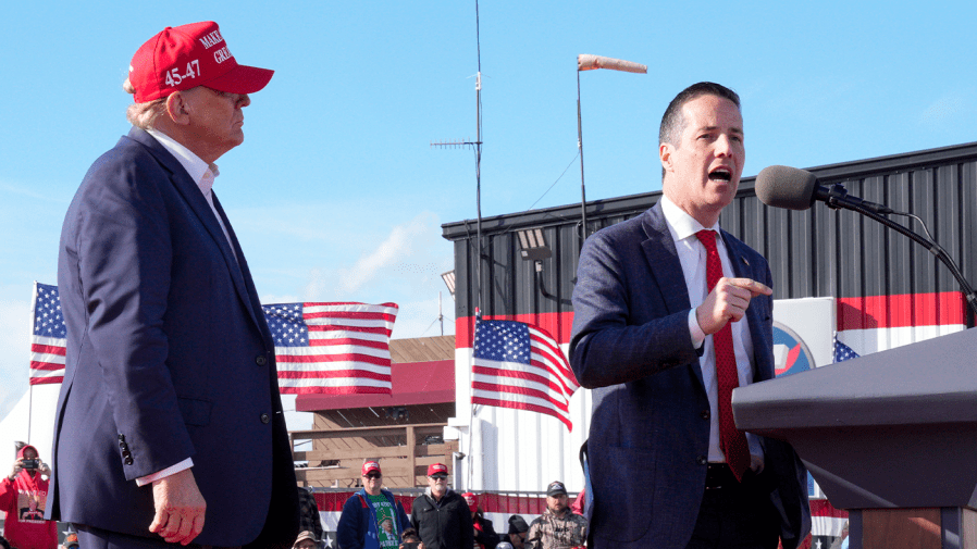 Republican presidential candidate and former President Donald Trump, left, listens as Senate candidate Bernie Moreno speaks at a campaign rally.