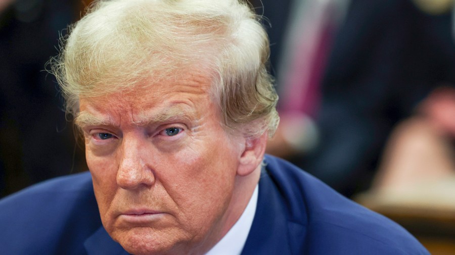 Former President Trump listens during one of his court cases.