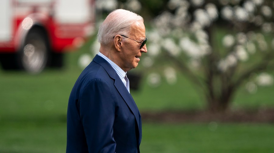 President Biden walks across the White House lawn.