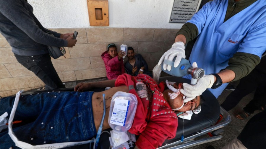 A wounded Palestinian girl receives emergency medical assistance at the entrance of Al-Najjar Hospital in Rafah.