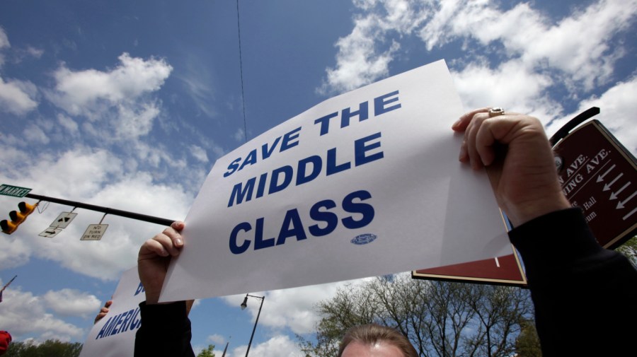 In this photo taken on Saturday, May 2, 2009, a participant holds up a sign during a pro-labor rally outside the Trumbull County Courthouse in Warren, Ohio.