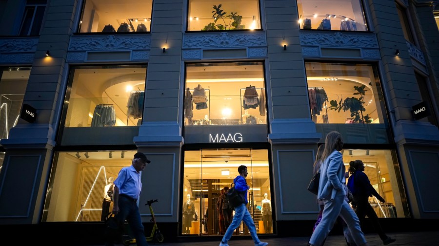 People walk past a newly opened Maag store, a former Zara flagship store, in Moscow, Russia, Monday, Aug. 21, 2023.