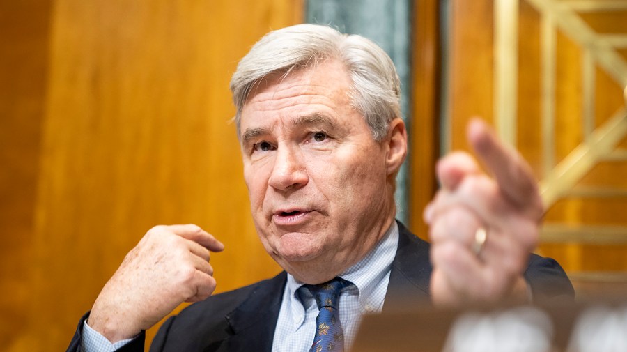 Senate Budget Committee Chair Sheldon Whitehouse points while speaking at a hearing.