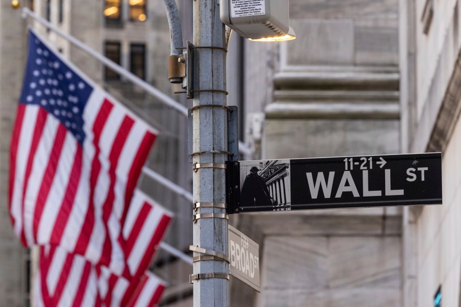 FILE - Signs at the intersection of Wall St. and Broad St. are shown outside the New York Stock Exchange, March. 21, 2024, in New York. (AP Photo/Yuki Iwamura, FILE)