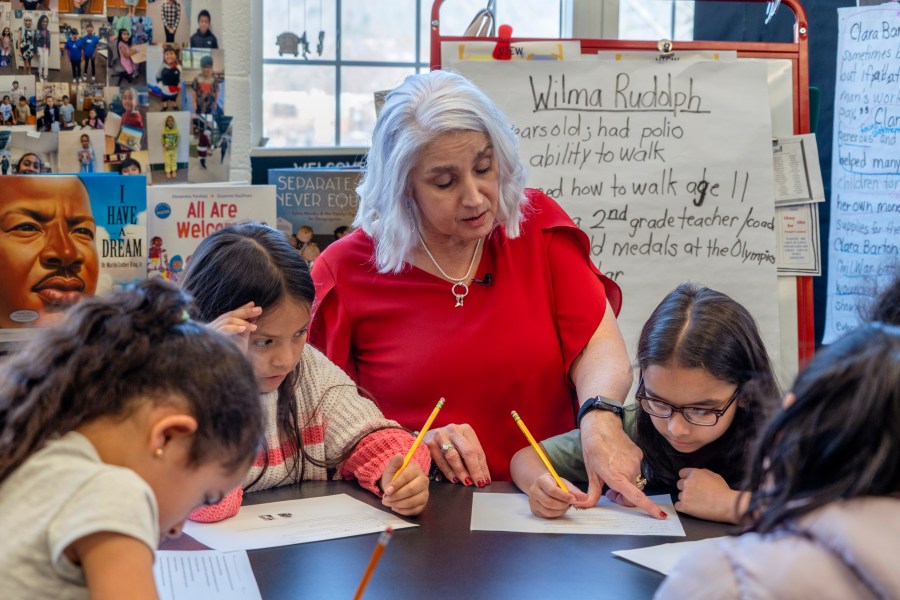 In this photo provided by the Tennessee Department of Education, 2nd grade teacher Missy Testerman, center, who teaches English as a second language, works with students Jana El Kammash, left, Dafne Lozano, and Dwiti Patel, right, at the Rogersville City School, Thursday, March 13, 2024, in Rogersville, Tenn. Testerman has been named the 2024 National Teacher of the Year by the Council of Chief State School Officers. (Tennessee Department of Education via AP)